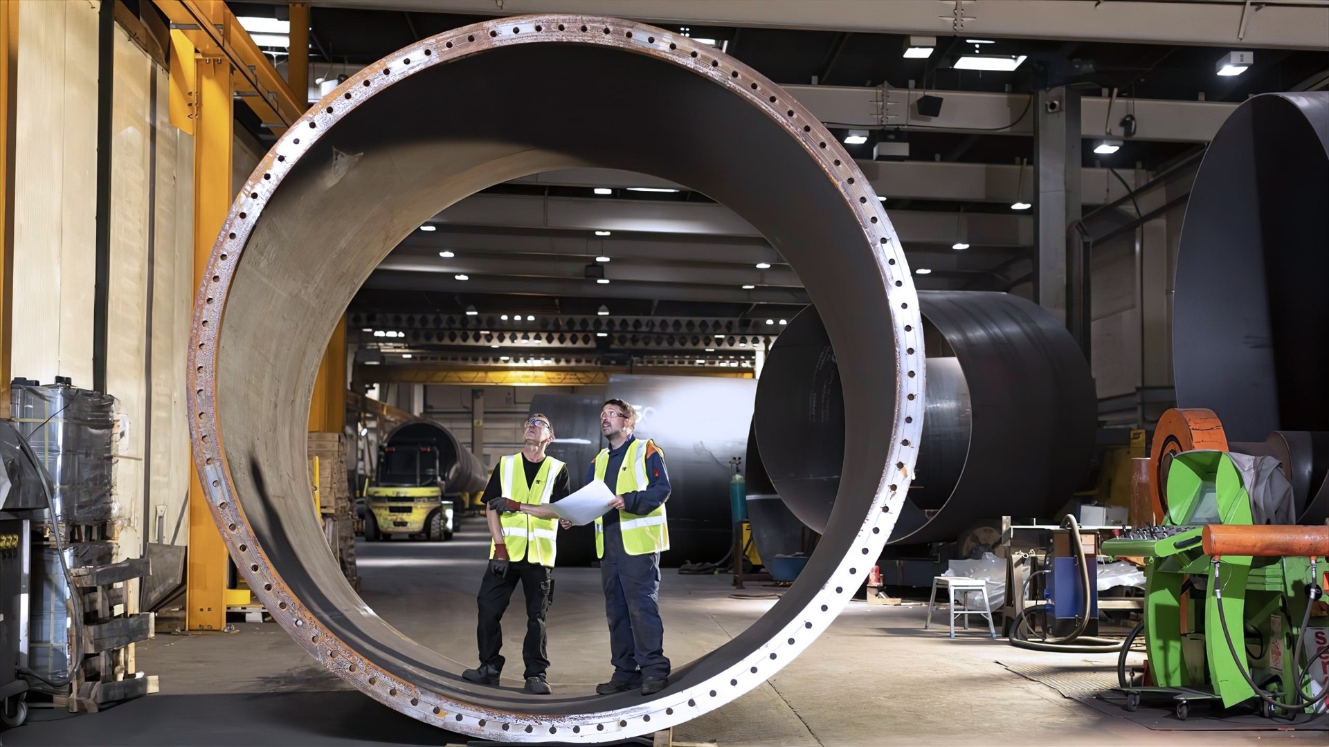 Two construction workers standing in a tunnel opening