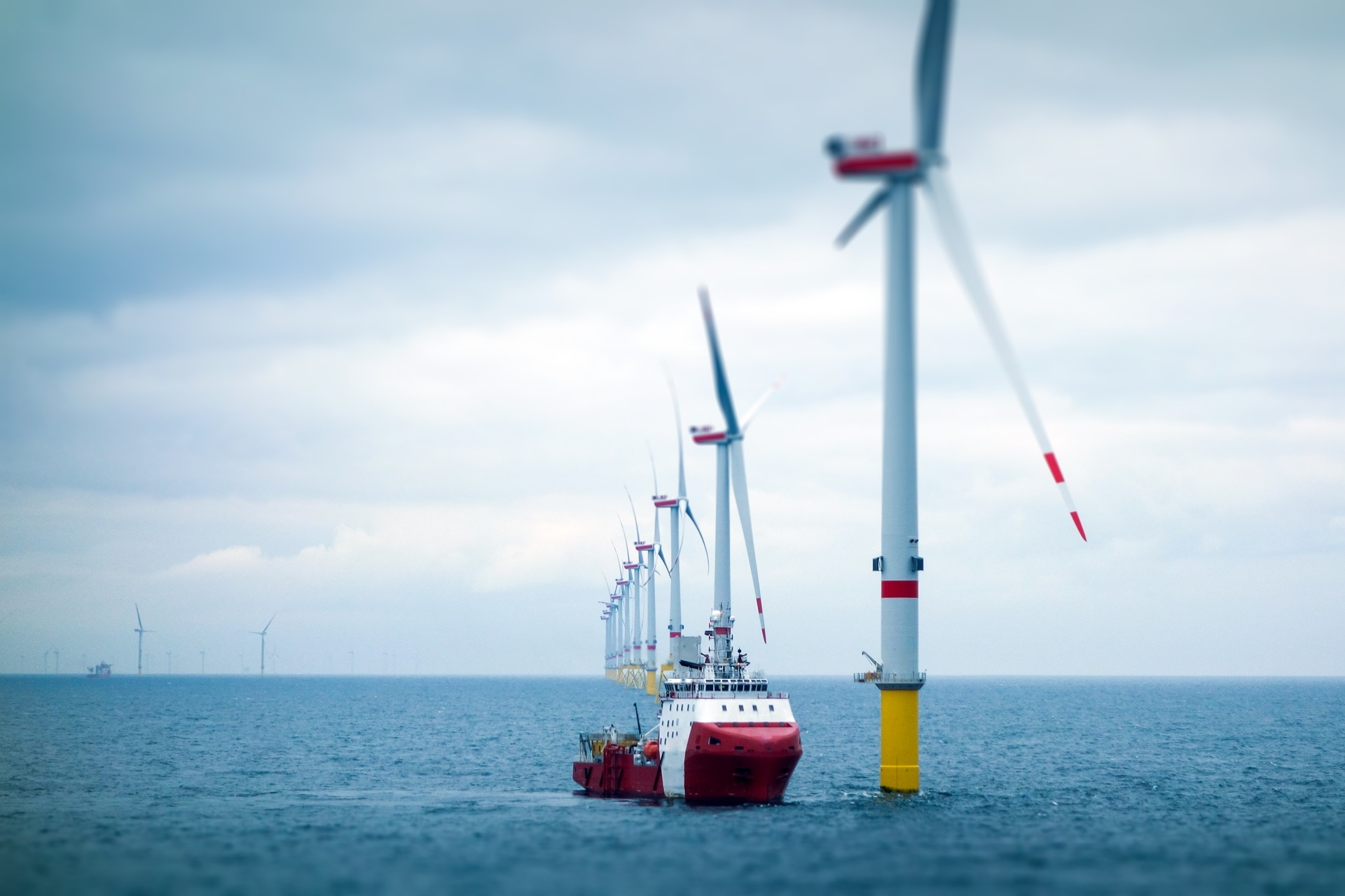 A ship sailing towards a windmill